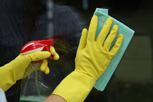 Professional home cleaners working in a Dulwich living room