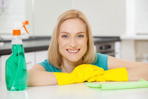 Cleaner wearing PPE while working in a property