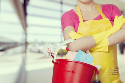 Team member following safe cleaning practices in a workspace